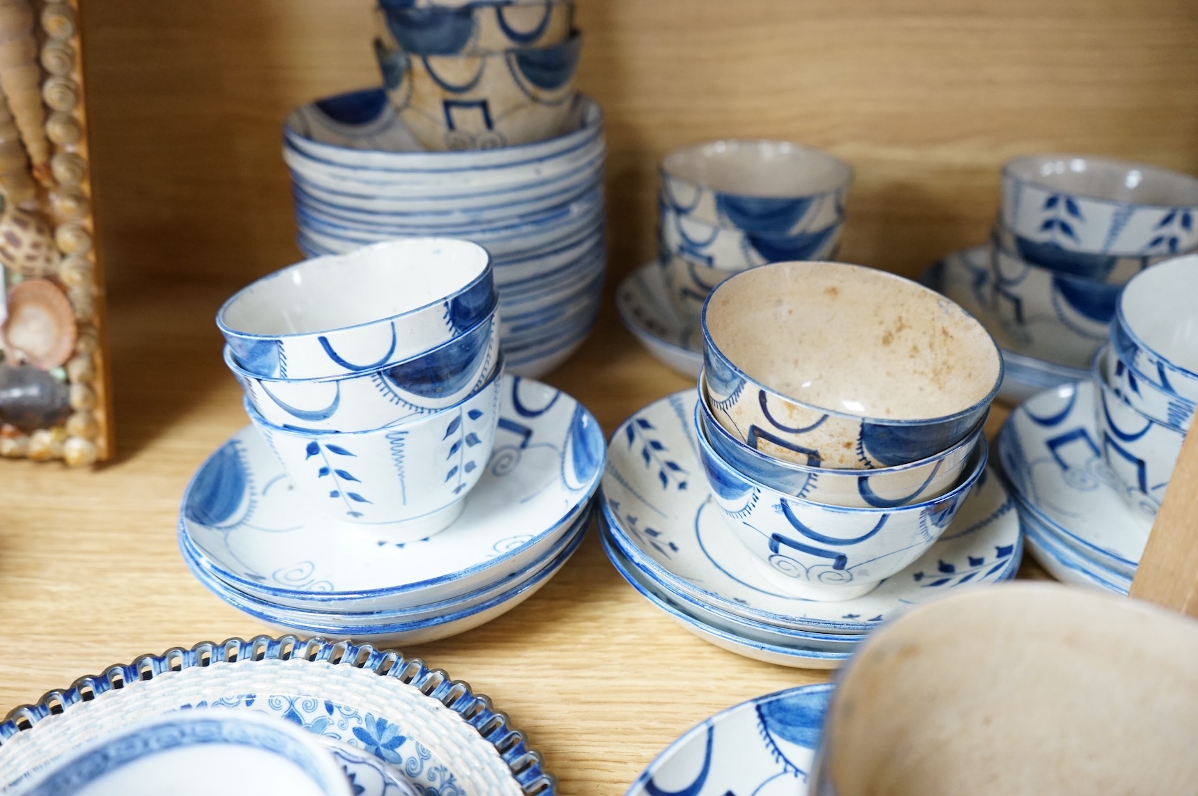 A group of 19th century pearlware set of tea bowls and saucers and to similar basket with border plates
